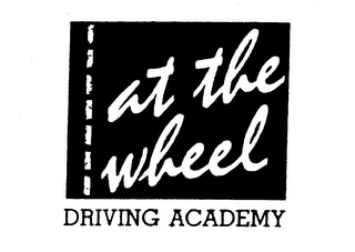 AT THE WHEEL DRIVING ACADEMY logo
