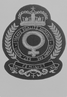 FEMINIST CREST WITH THE WORDS LIBERTE, EGALITE, HUMANITE, SUZANNE RAE logo