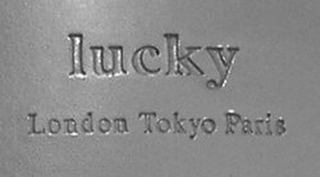 LUCKY LONDON TOKYO PARIS logo