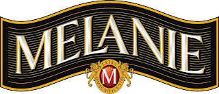 MELANIE M EXTRA MAGNIFICENT logo