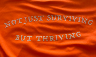 NOT JUST SURVIVING BUT THRIVING logo