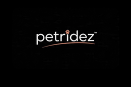 PETRIDEZ WITH A ANIMAL PAW THAT IS PINK ON THE I IN THE WORD RIDEZ WITH A PINK LINE UNDER THE NAME logo