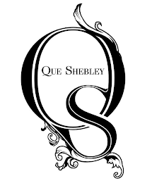 QS QUE SHEBLEY logo
