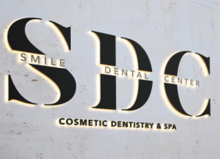 SDC SMILE DENTAL CENTER COSMETIC DENTISTRY & SPA logo