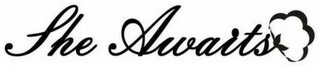 SHE AWAITS logo