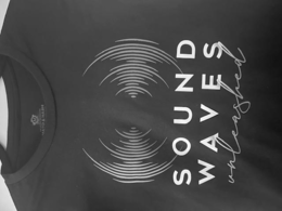 SOUND WAVES UNLEASHED: SOUND ON TOP OF WAVES, BOTH WORDS IN UPPER CAPS PRINT, UNLEASHED ON THE BOTTOM IN LOWER CASE CURSIVE. logo
