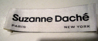 SUZANNE DACHE PARIS NEW YORK logo