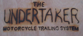 THE UNDERTAKER MOTORCYCLE TRAILING SYSTEM logo