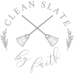 THE WORDS CLEAN SLATE IN SERIF FONT ABOVE TWO BROOMS CROSSED IN AN X SHAPE, BORDERED BY BRANCHES ON THE LEFT AND RIGHT ABOVE THE WORDS BY FAITH IN A CURSIVE FONT, ALL CREATING A CIRCLE SHAPE. logo