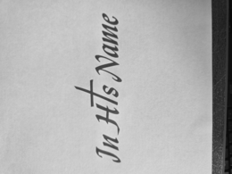THREE WORDS "IN HIS NAME" WITH THE LETTER "I" IN THE WORD "HIS" BEING REPLACED BY A CROSS SYMBOL. logo