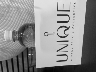 UNIQUE A REAL ESTATE COLLECTIVE logo