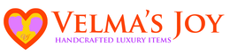 VELMA'S JOY HANDCRAFTED LUXURY ITEMS logo